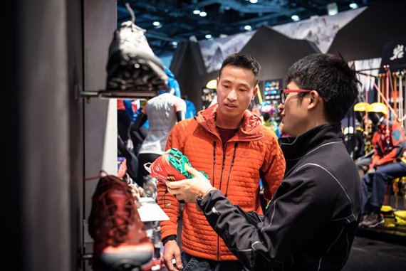 Salesperson shows customer sports shoes