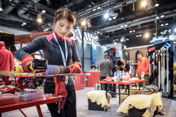 Woman waxing a snowboard