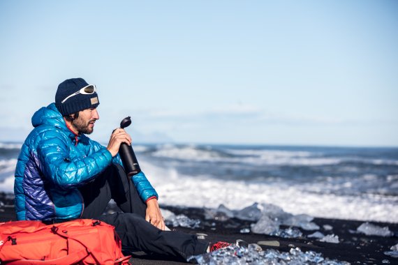 Man with his Thermos bottle drinking 