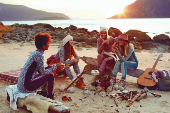 A group of women sitting on the beach