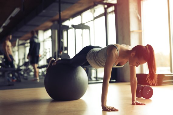 Frau trainiert auf Gymnastikball