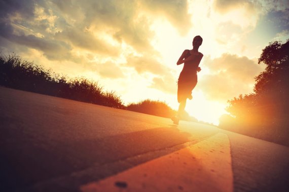 A woman running at sunset