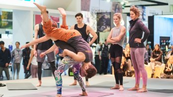 Credit: Messe München GmbH At the ISPO Munich 2019 Climbing Yoga was presented for the first time. During the exercises you climb up and down your partner while taking different positions.