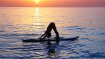 Credit: istockphoto.com/Anna_Om SUP-Yoga promotes concentration and balance, since the exercises are carried out on the water on a surfboard.