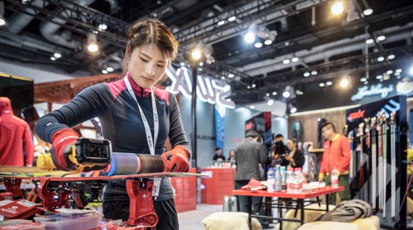 Woman waxing a snowboard