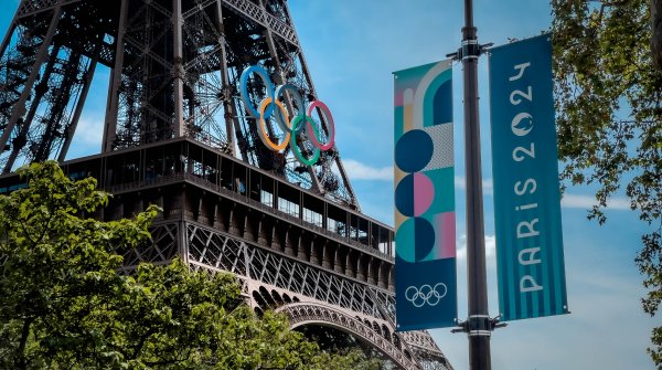 The Olympic rings hang from the Eiffel Tower