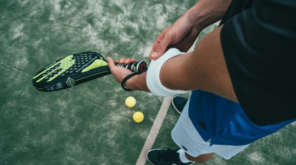 Bird's eye view of man holding padel racket