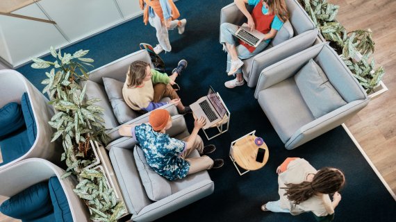 Employees working in the seating area of an office